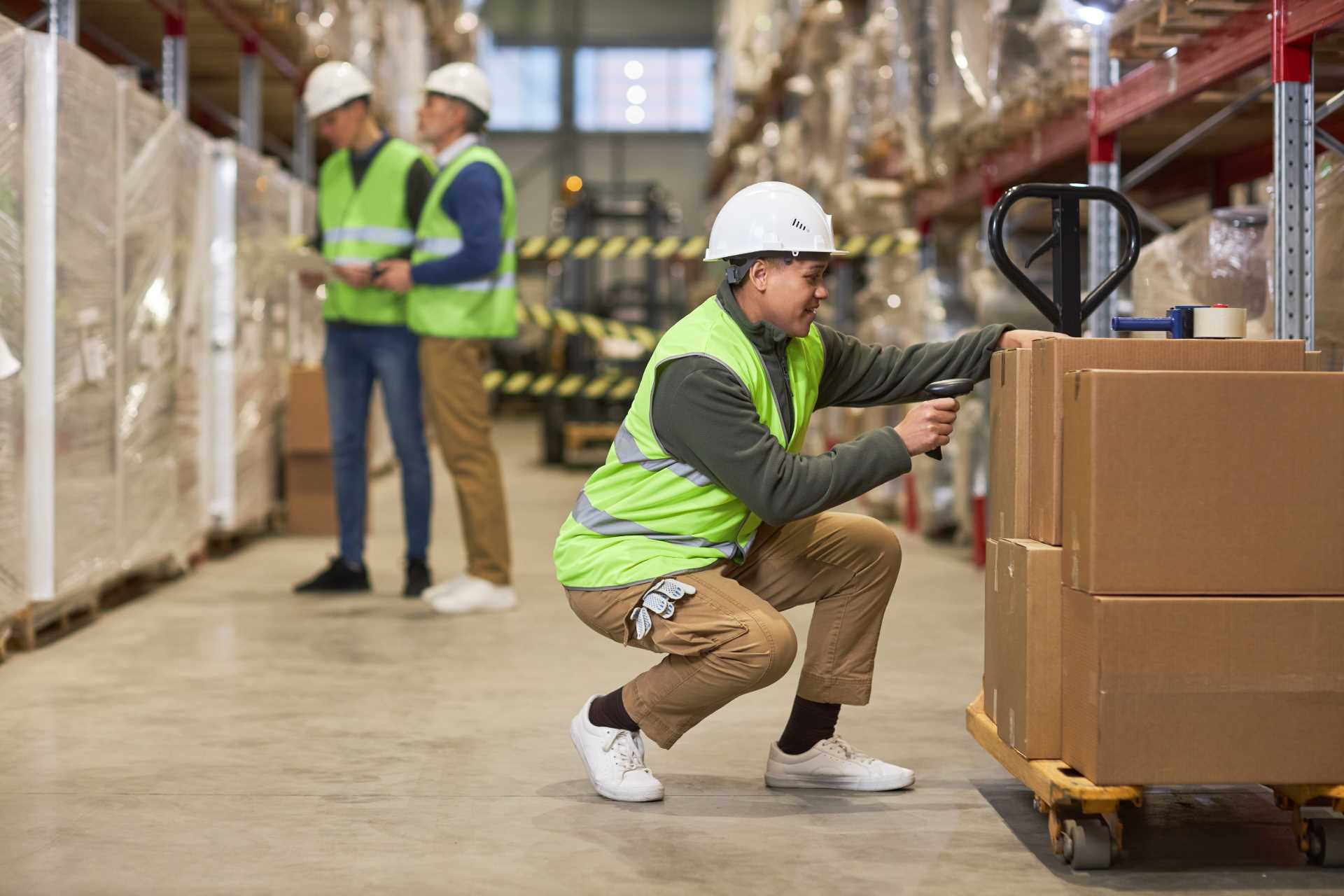 Female worker scanning codes on boxes in warehouse Columbus, IN 3PL Warehouse Solutions